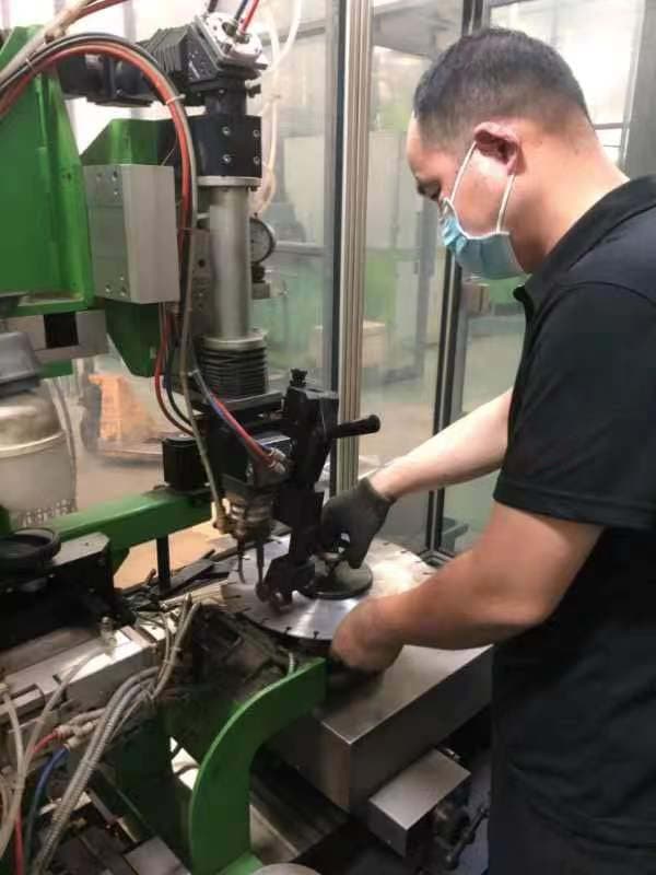 worker laser welding the blade